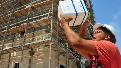 A constuction worker copes with the heat. 