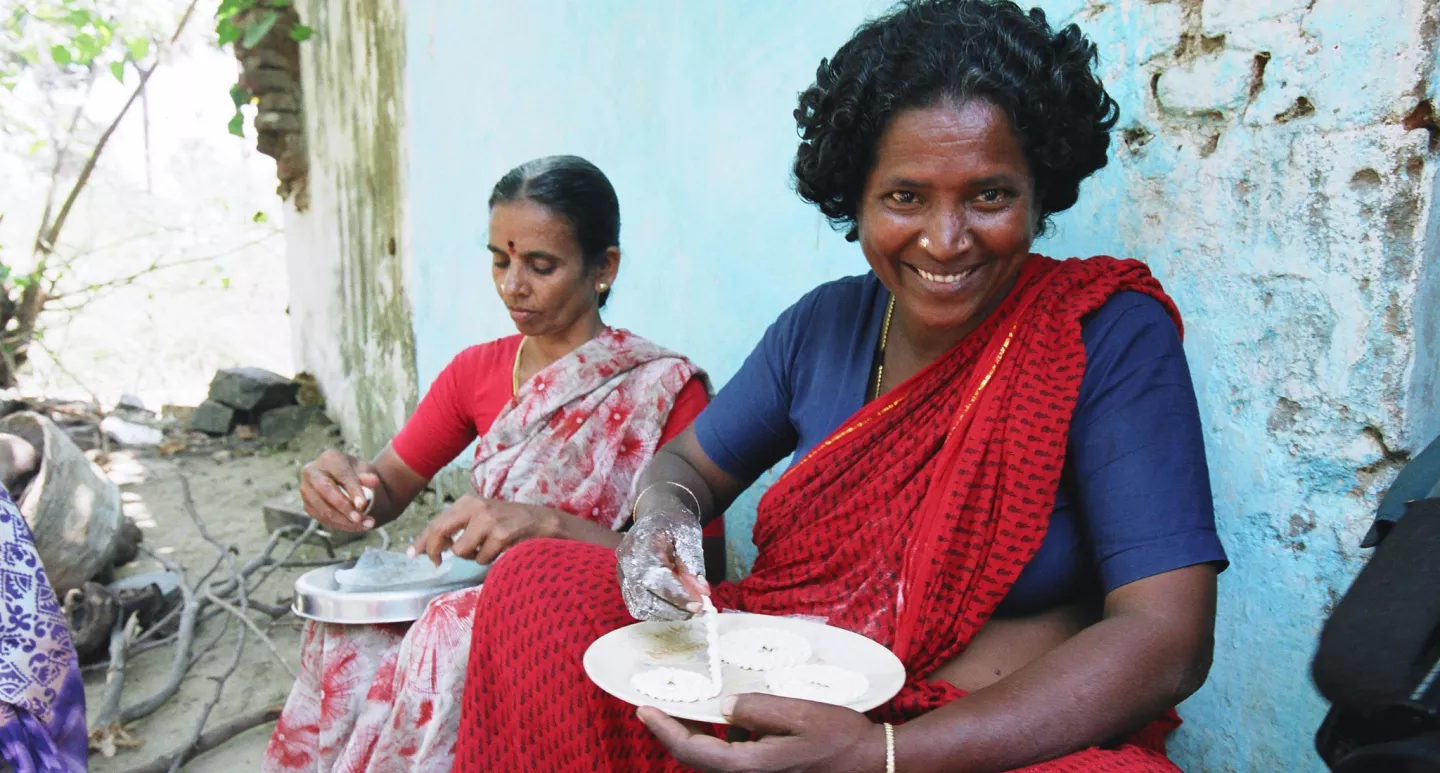 Two women from the Kesavarayanpettai rural cooperative prepare home-made cookies, India